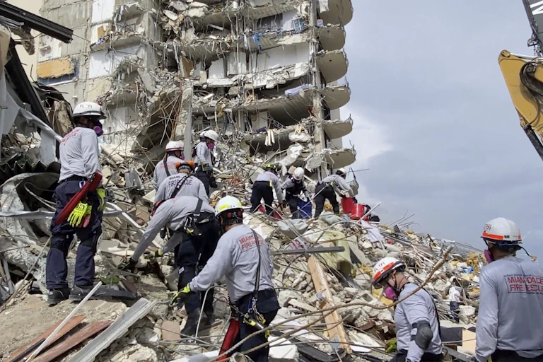 Rescuers search for survivors in a collapsed building