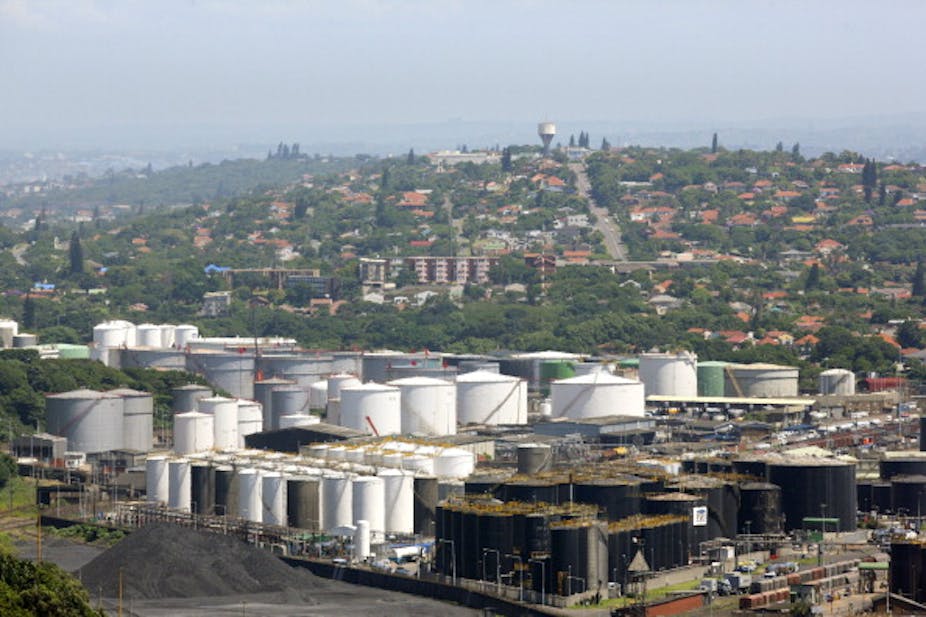 View of city with large storage tanks in the foreground