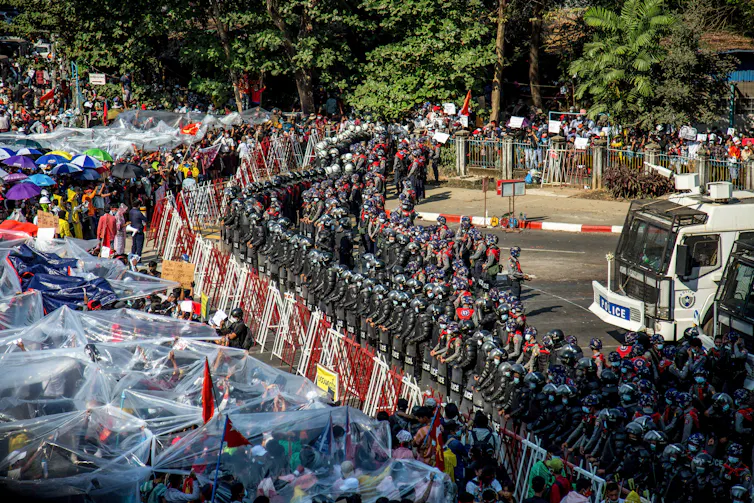Protestors in Yangon face off with police.