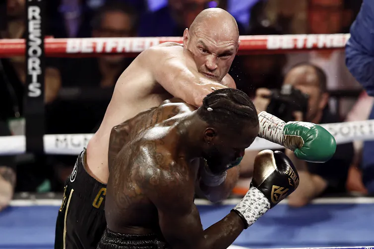 Tyson Fury throwing a punch at Deontay Wilder during a title fight in the US.