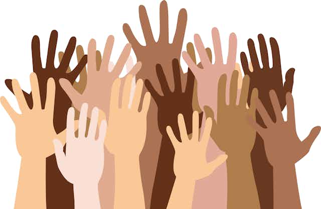 An illustration of a dozen children's hands raised in the air, each a different skin tone.
