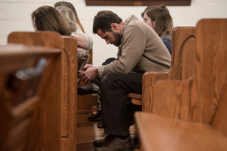People bow their heads in prayer during a Sunday evening service at Grace Orthodox Presbyterian Church in Lynchburg, Virginia.