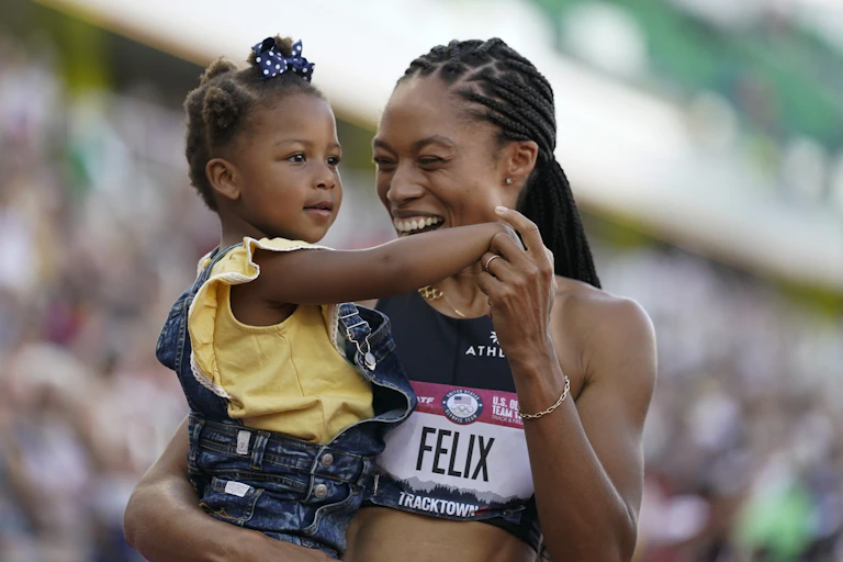 Woman holding a young girl in her arms and smiling