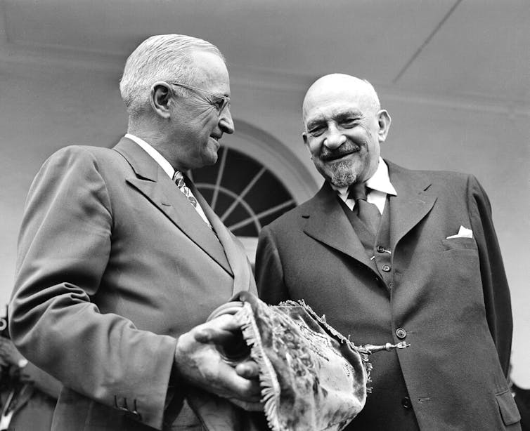 U.S. President Harry S. Truman holds a copy of the Torah, presented to him by Chaim Weizman, right, in Washington on May 25, 1948.