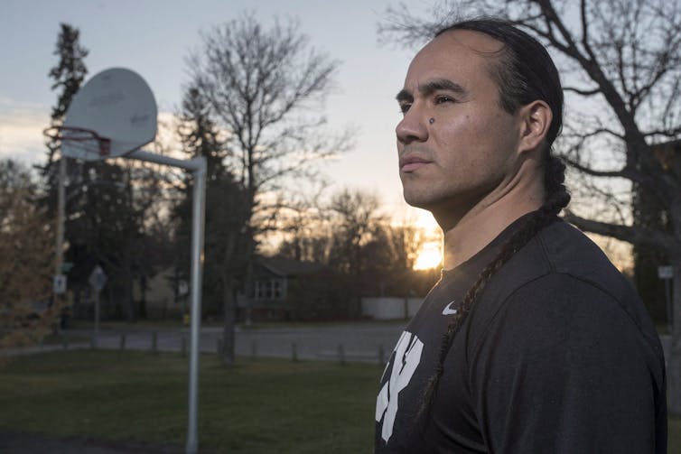 Michael Linklater stands for a photograph at a outdoor basketball court near his home in Saskatoon.