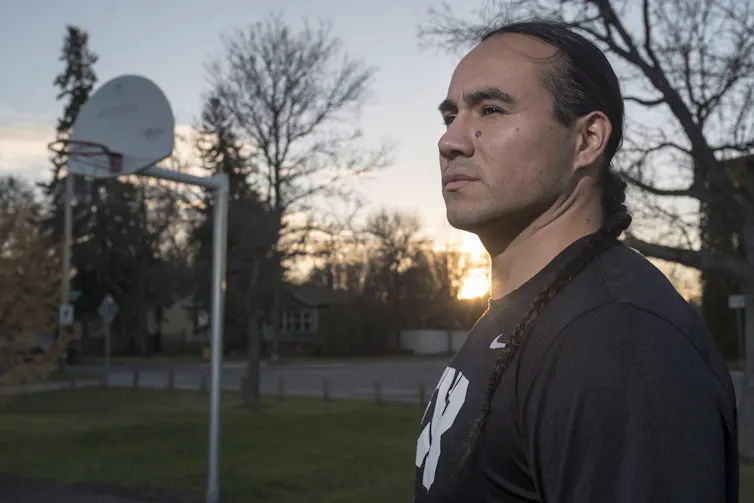 Michael Linklater stands for a photograph at a outdoor basketball court near his home in Saskatoon.