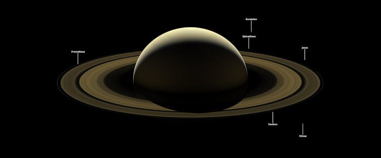 Saturn and several of its moons, backlit, as seen from the Cassini spacecraft in September 2017.