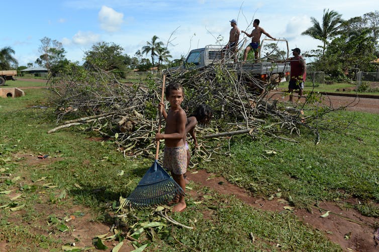 children rake branches