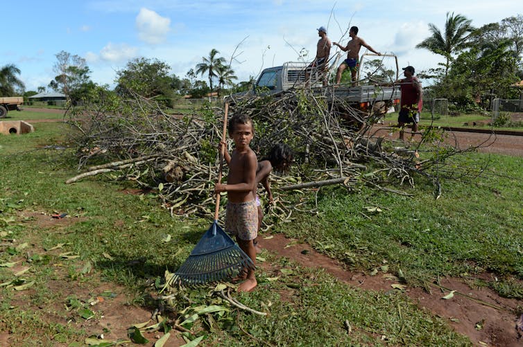 children rake branches