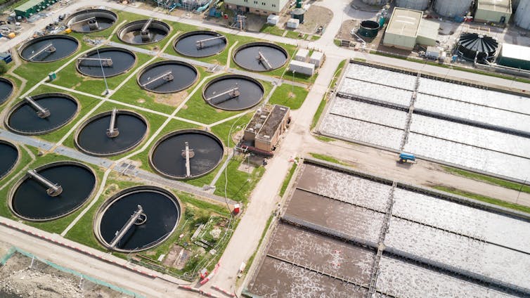 An aerial view of purification tanks and ponds at a waste water treatment works.