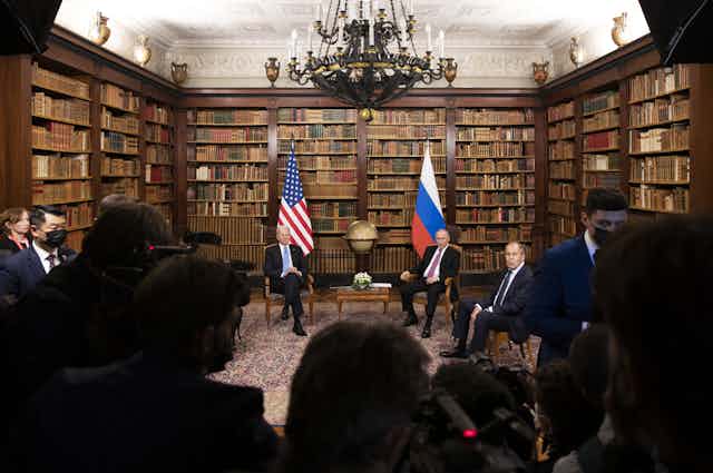 An image of Biden and Putin sitting beneath their respective flags in the library of the Villa La Grange, Geneva on June 16 2021.