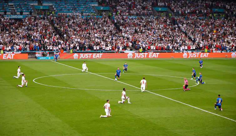 England and Italy football teams take a knee on the Wembley Stadium pitch before Euro 2020 final