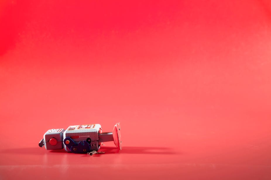 Broken robot against a red background