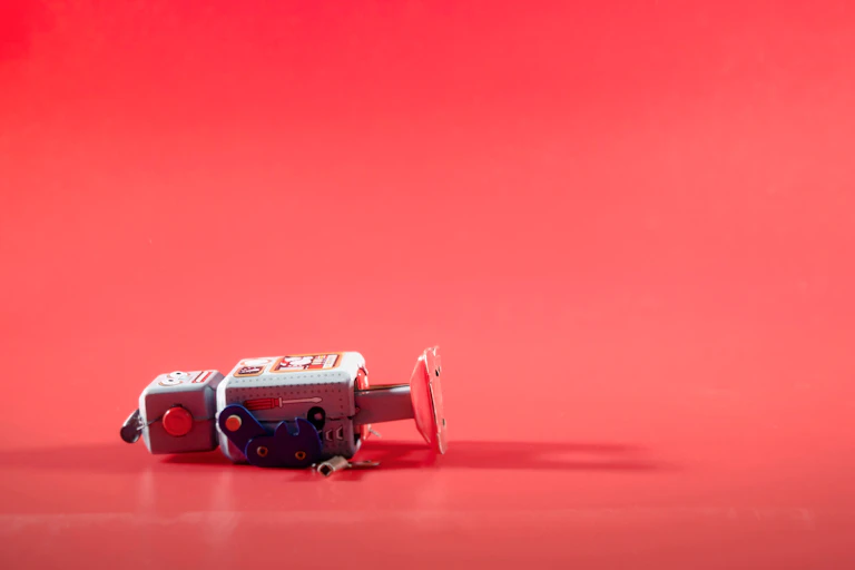 Broken robot against a red background
