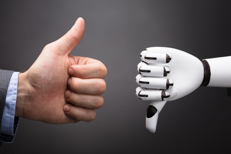 Businessman thumb up, robot thumb down