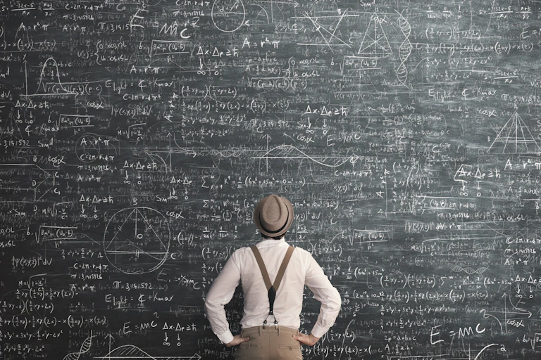 A man consults a large blackboard of equations