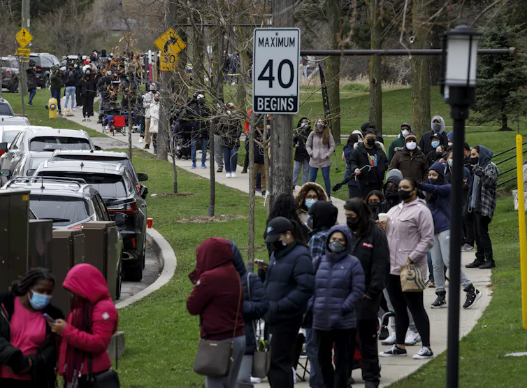 Cientos de personas hacían fila en la acera esperando ser vacunadas