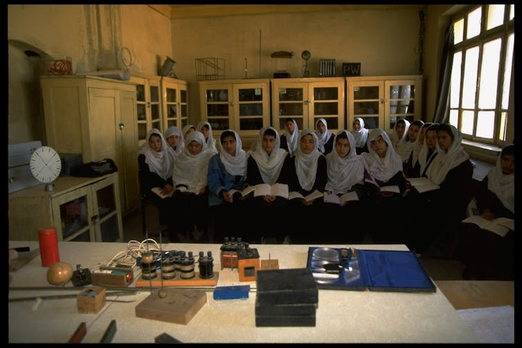 Afghan girls study science at a government-run girl's high school.