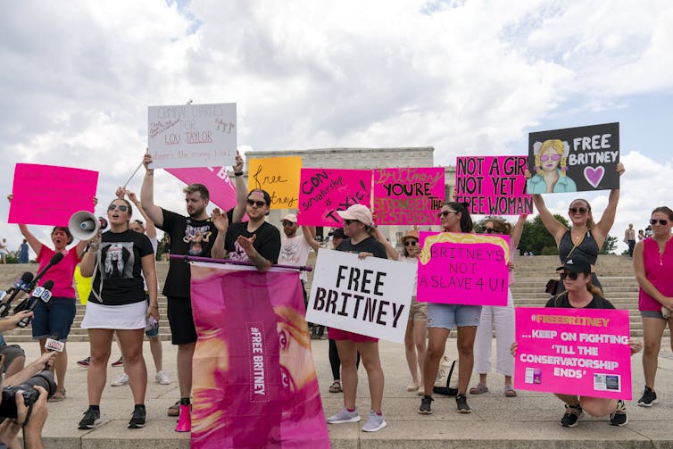 Fans of Britney Spears hold up signs with such messages as 'Free Britney' at the steps of the Lincoln Memorial in Washington