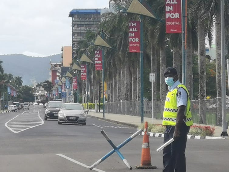 Fijian police officer at roadblock in Suva