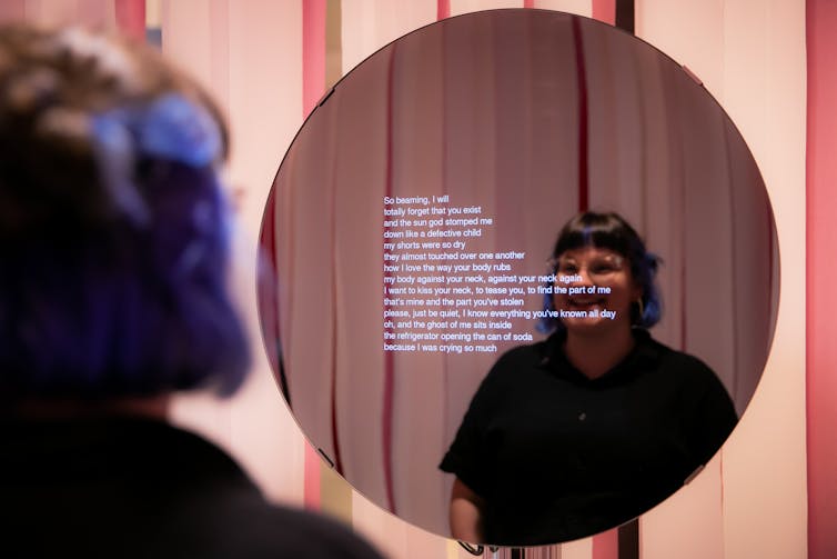 woman reads poem in mirror