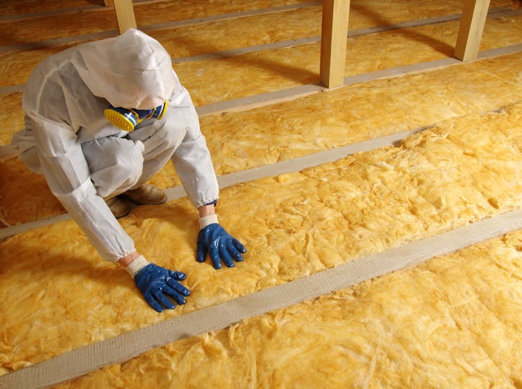 person installs insulation