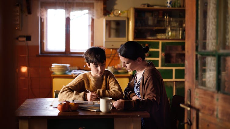 mother and child sit at table