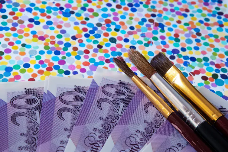 Damien Hirst's The Currency overlaid with paintbrushes and twenty pound notes