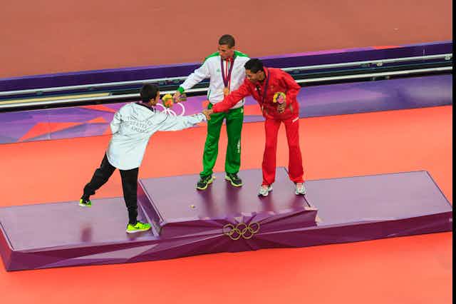 Athletes congratulate each other on the podium during the London 2012 Olympic Games
