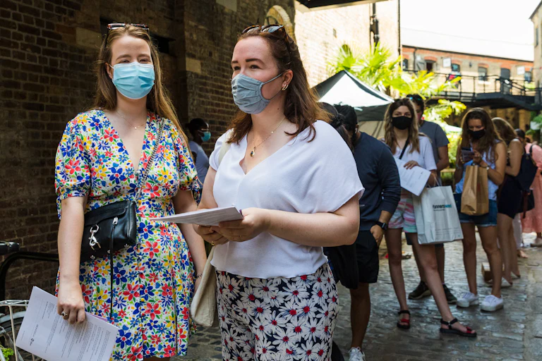 Young people queuing at a pop-up vaccine centre in Camden, London