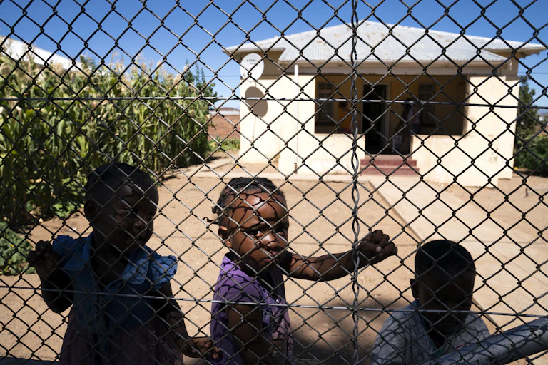 Three children at the Compassionate Hearts soup kitchen in Touws River, in the Western Cape region of South Africa.