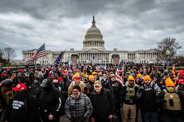 A group of angry people rallying in front of the US Capitol on January 6, 2021.