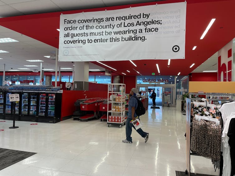 Sign inside the target indicating that masks must be worn