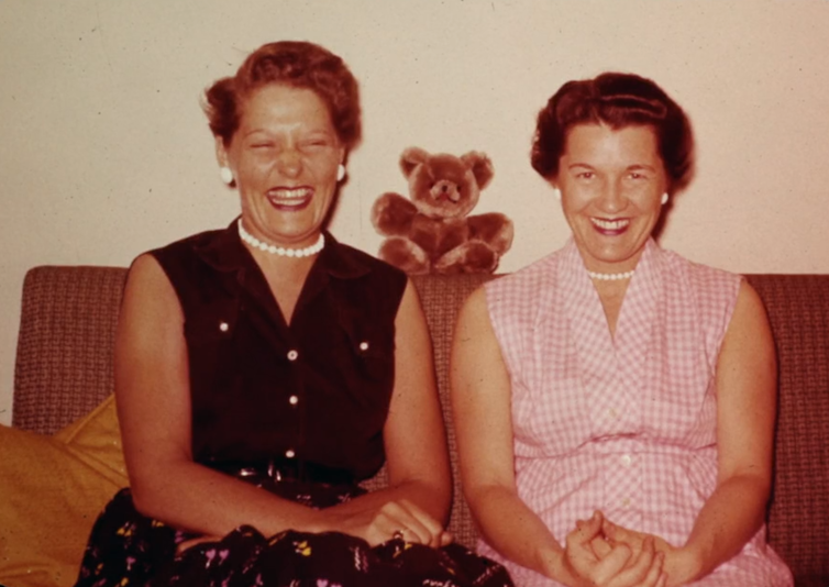 Two smiling women sitting on a couch