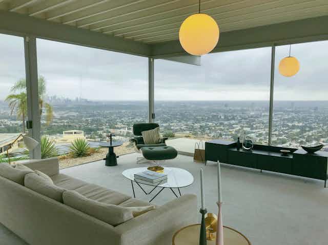 An elevated lounge room looks over a far away city