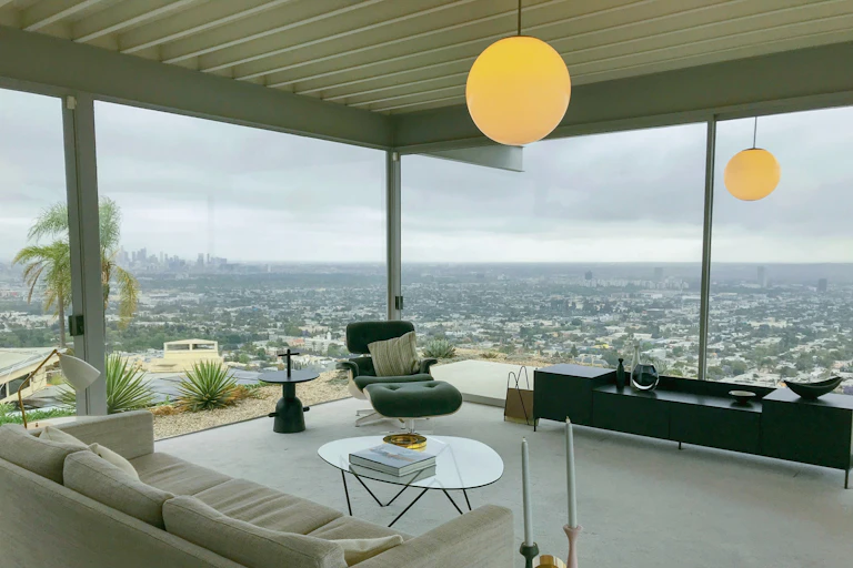 An elevated lounge room looks over a far away city
