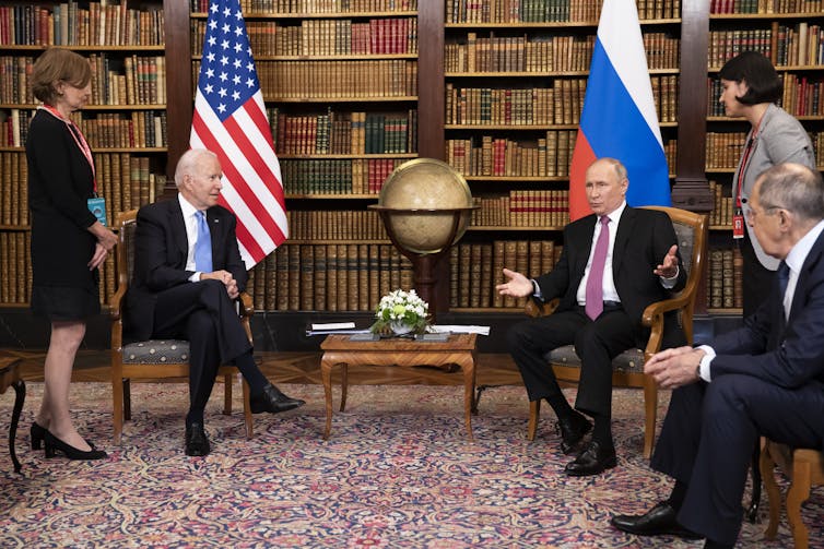 US president Joe Biden and Russian president Vladimir Putin surrounded by aides at a summit meeting in Geneva in June 2021.