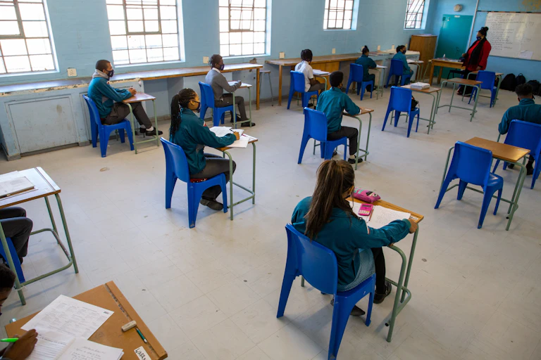 students sitting socially-distanced in class