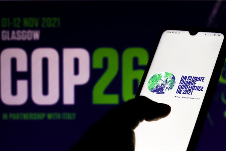 COP26 logo on screens.