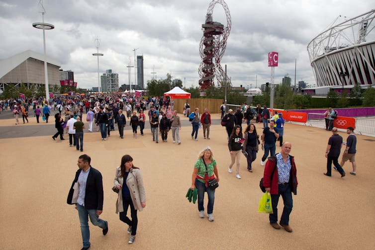 Visitors walk around the enclosed London 2012 Olympic Park in Stratford, East London