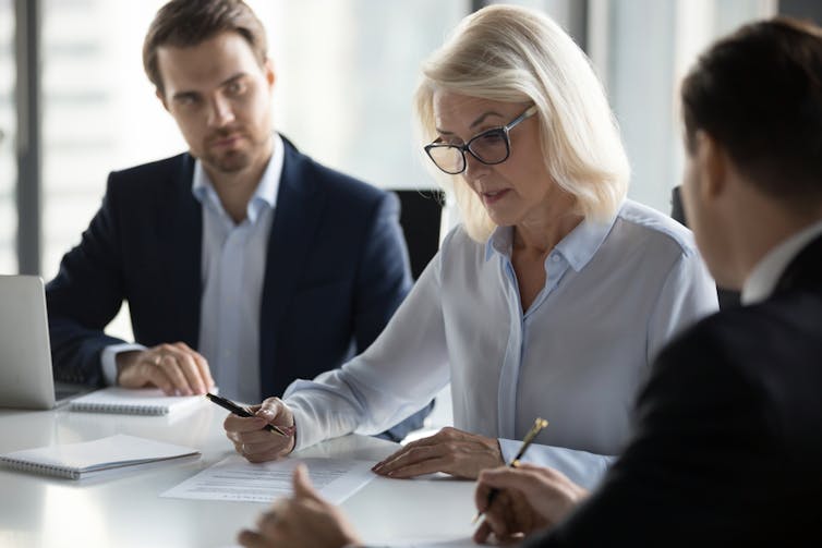 Three auditors at a desk