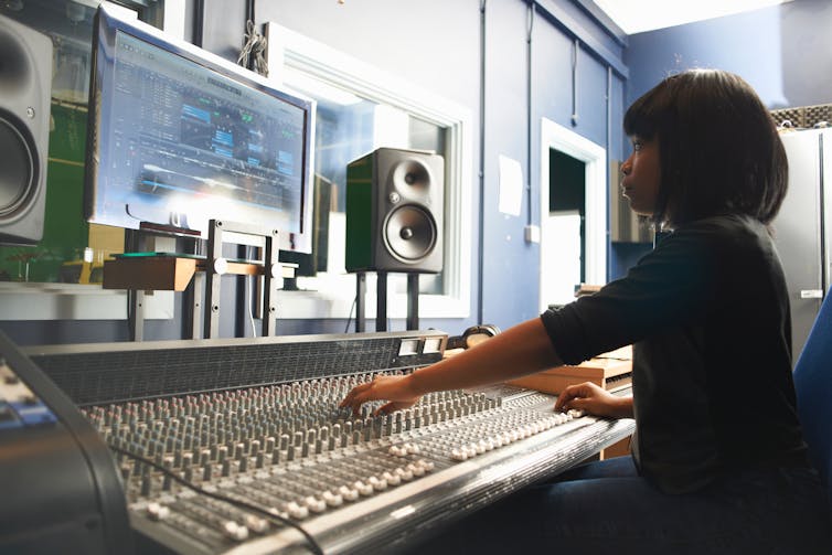 A young girl uses a soundboard.