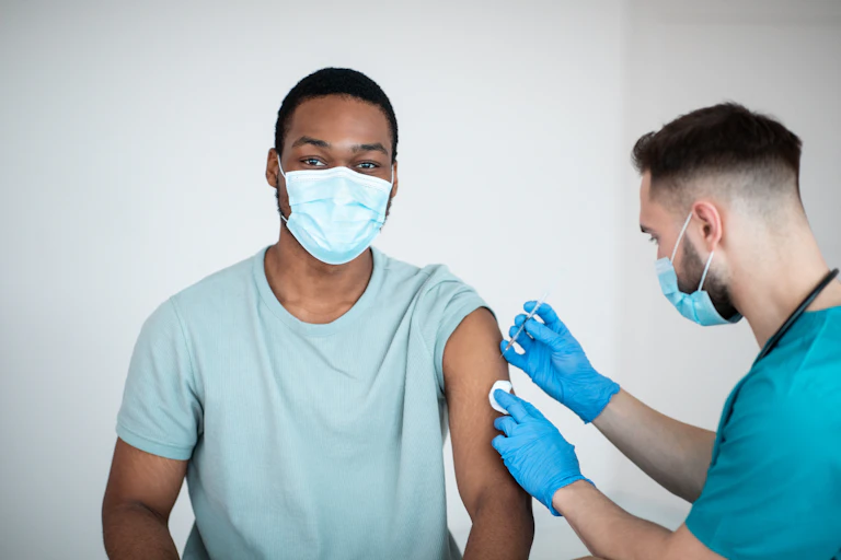 A young man receives a vaccination.