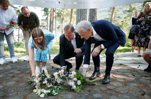  Leader of AUF in Norway, Astrid Hoem, Prime Minister of Sweden Stefan Loefven and leader of the Norwegian Labor Party Jonas Gahr Store lay flowers at a memorial for the victims of the Utoya massacre.