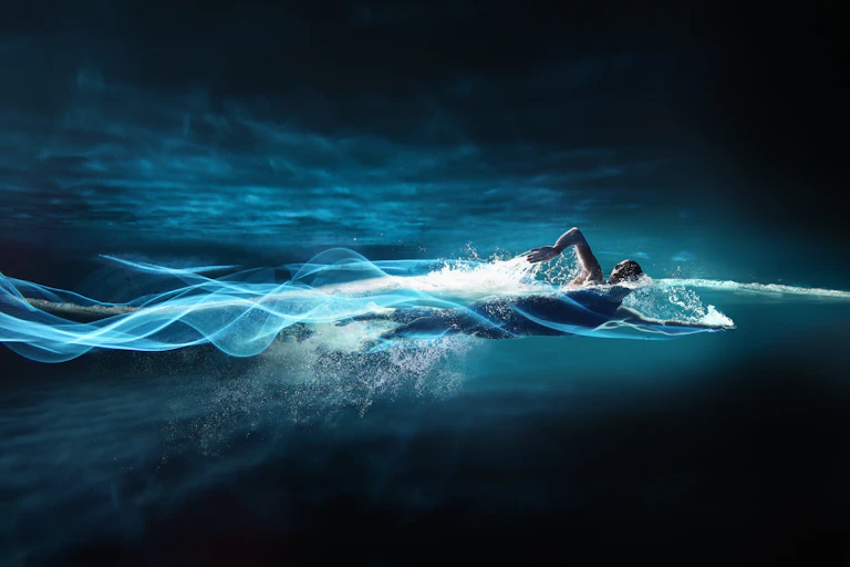 Person swimming, leaving streaks of light in path