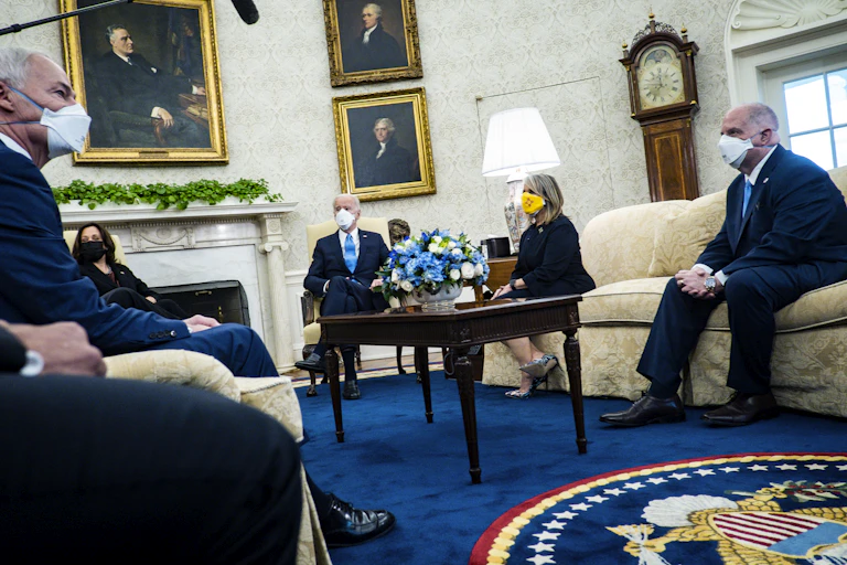 President Biden meeting in the Oval Office with VP Harris and mayors and governors, all masked.