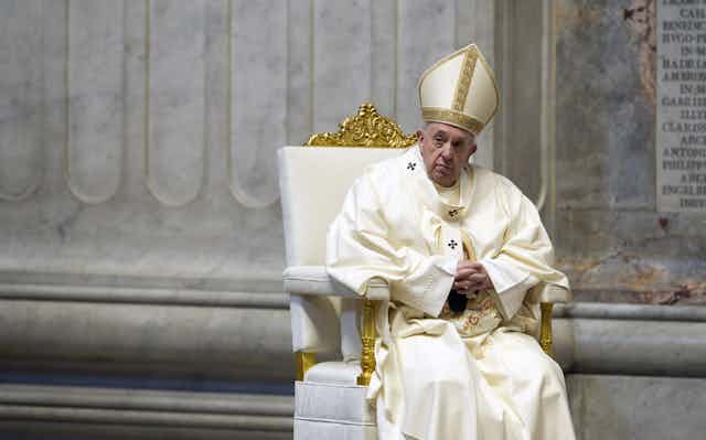 Pope Francis seated during a celebration of Holy Mass.