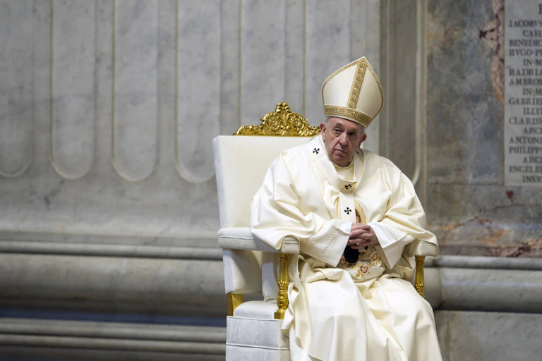 Pope Francis seated during a celebration of Holy Mass.