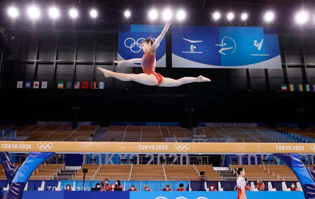 Aiko Sugihara (top) of Japan practices for the Tokyo Olympics on July 22, 2021, at Ariake Gymnastics Centre.