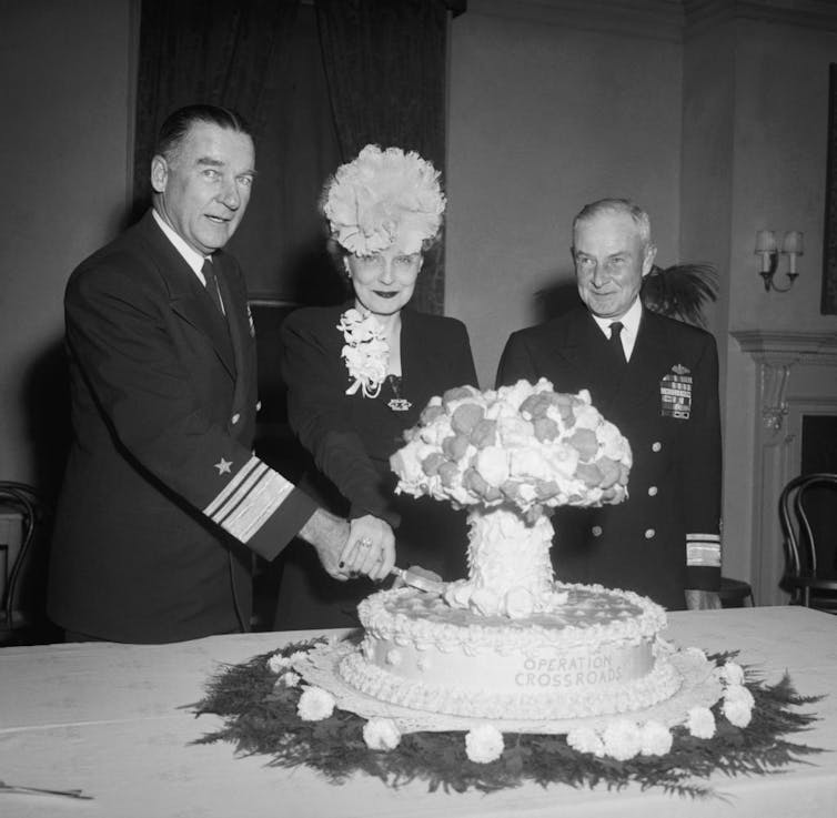 Mushroom cloud cake is cut.